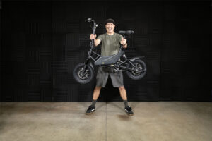 Walker holding the mini e-bike